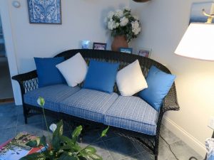 Wicker sofa with removable seat cushions and back pillows | Upholstered in a Stout Fabrics and Greenhouse Fabrics stripe and solid | Upholstered by Cape Cod Upholstery Shop | Located in South Dennis, MA 02660