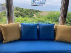 85" window seat with four 18" square throw pillows | Cushion covers upholstered with JF & Greenhouse Fabrics | Upholstered by Cape Cod Upholstery Shop | Located in South Dennis, MA 02660