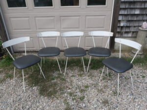 Outdoor dining chairs with a painted metal frame and curved wood back | Upholstered in a Greenhouse Fabrics faux leather from the "Value Vinyl" line |