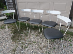 Outdoor dining chairs with painted metal frames and curved wood backs | Upholstered in a Greenhouse Fabrics faux leather from the "Value Vinyl" line | Upholstered by Cape Cod Upholstery Shop | Located in South Dennis, MA 02660
