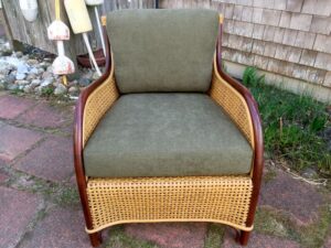 Cane chair with mahogany wood trim | Loose seat and back cushions upholstered in a Greenhouse Fabrics solid dark green chenille | Upholstered by Cape Cod Upholstery Shop | Located in South Dennis, MA 02660