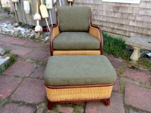 Cane chair and matching ottoman with mahogany wood trim | Loose seat and back cushions upholstered in a Greenhouse Fabrics solid dark green chenille | Upholstered by Cape Cod Upholstery Shop | Located in South Dennis, MA 02660