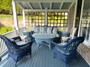 Three Piece Wicker Set, painted in blue on a covered porch | Cushion covers fabricated in a Perennials stripe indoor-outdoor fabric | Cushion inserts are rated for outdoor use | Cushions fabricated by Cape Cod Upholstery Shop | Located in South Dennis, MA 02660