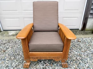 Lions foot oak Morris Chair | Loose seat and back cushion covers upholstered in a Sunbrella Dupione chestnut brown fabric | Morris Chair frame refinished by Wesley Woodworking in Orleans, MA | Cushion Covers upholstered by Cape Cod Upholstery Shop | Located in South Dennis, MA 02660