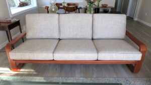Teak sofa frame with 6 loose cushions in a Cape Cod condominium. All new high density foam seat cushions supported by Pirelli rubber webbing | Upholstered by Cape Cod Upholstery Shop | Located in South Dennis, MA 02660