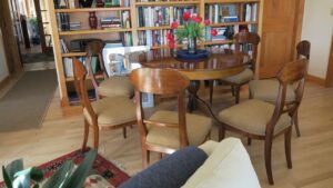Pecan Wood dining room chairs with an upholstered seat. Upholstered in a Revolutions Fabrics South Paw color mustard fabric. Upholstered by Cape Cod Upholstery Shop | Located in South Dennis, MA 02660