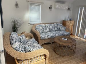 Wicker Set Photo #2. Wicker sofa and love seat with loose seat and back cushions. Cushion covers fabricated with a screen printed blue & white floral print. Cushions fabricated by Cape Cod Upholstery Shop | Located in South Dennis, MA 02660