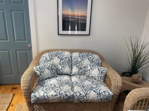 Wicker Set Photo #4 Wicker sofa and love seat with loose seat and back cushions. Cushion covers fabricated with a screen printed blue & white floral print. Cushions fabricated by Cape Cod Upholstery Shop | Located in South Dennis, MA 02660