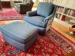 Matching chair and ottoman from the front view. Upholstered in coordinating fabrics using JF Fabrics Freestyle, Sunbrella Spectrum and a toile print. Upholstered by Cape Cod Upholstery Shop | Located in South Dennis, MA 02660