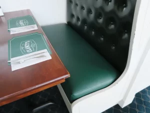 Clancy's Restaurant in South Dennis, MA 48" upholstered booth seat. Upholstered with a Greenhouse Fabrics commercial grade green vinyl material. Upholstered by Cape Cod Upholstery Shop | Located in South Dennis, MA 02660