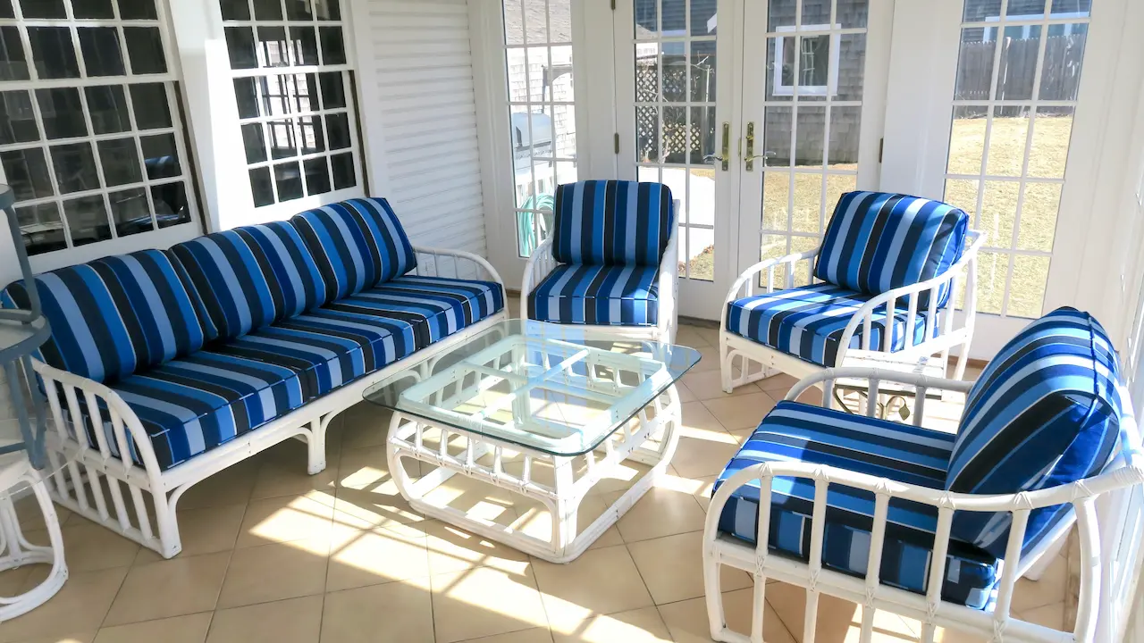 Three season room with white rattan chairs and sofa. Cushions fabricated with Sunbrella Milano Cobalt. All new CertiPur-US upholstery foam. Cushions fabricated by Cape Cod Upholstery Shop - South Dennis, MA 02660